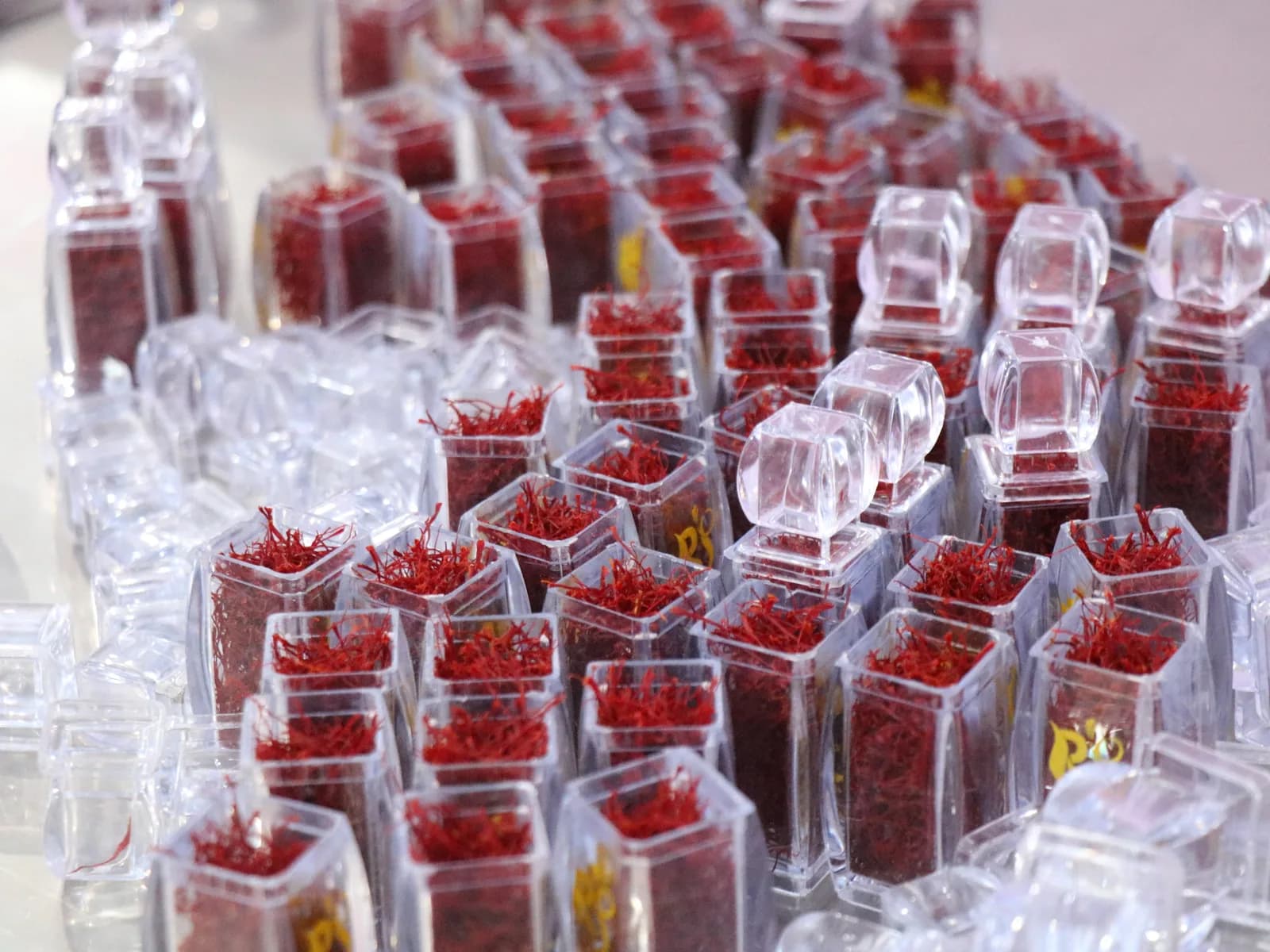 Rows of sealed retail jars of Afghan saffron filaments, ready for despatch